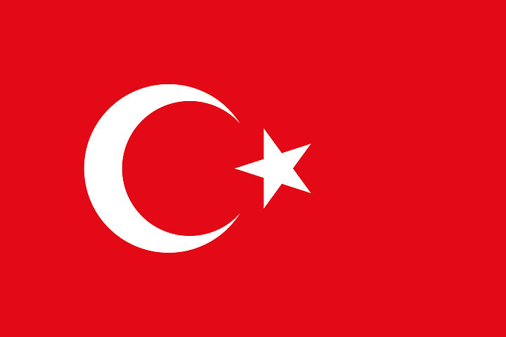 A red flag with a white crescent and star on the left.
